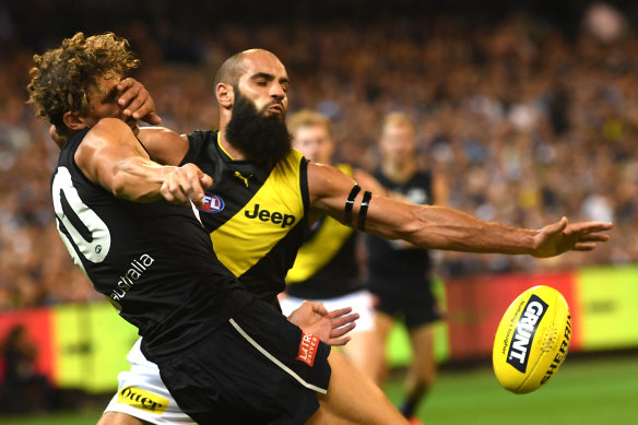 Tiger Bachar Houli takes on Carlton's Charlie Curnow  in round one of the 2019 AFL season.