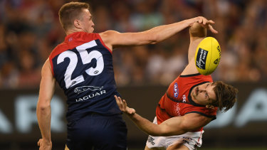 Unorthodox: Essendons Patrick Ambrose approaches his contest with Tom McDonald from a new angle. 