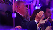 Donald Trump claps from his private suite during the NBA Finals.