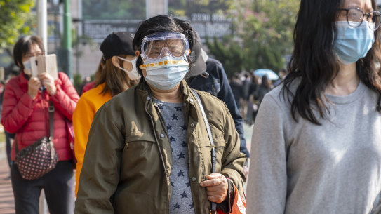 A customer wearing safety goggles and a protective mask stands in line to purchase protective masks in Hong Kong, China, on Saturday, February 1.