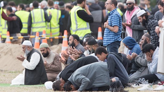 Mourners pray as funerals continue. 