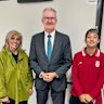 Iranian team support staffer  Zahra Soltan Moshkehkar, Home Affairs Minister Tony Burke and player Mohaddeseh Zolfi, a 21-year-old forward, pictured in Brisbane on Tuesday night after they decided to seek asylum. 