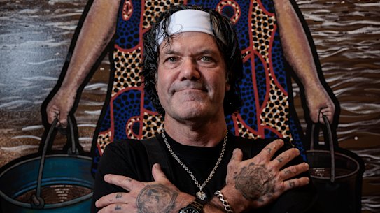 Blak Douglas in front of his winning Archibald portrait, Moby Dickens.