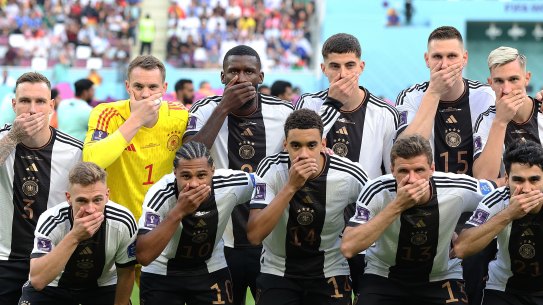 German players cover their mouths in a team photo to protest FIFA’s refusal to let them wear diversity armbands.