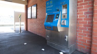 Receipts litter the ground in front of a myki machine in Brunswick.