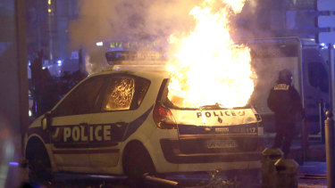 A police car burns after clashes between police and protesters, in Marseille, southern France, on Saturday.