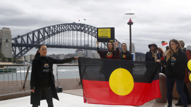 Cheree Toka and fellow demonstrators hold an Aboriginal Flag during a demonstration in June calling for the flag to be permanently flown atop the Sydney Harbour Bridge.