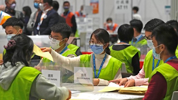 Election workers count votes at a polling station in Hong Kong after the legislative election on Sunday.