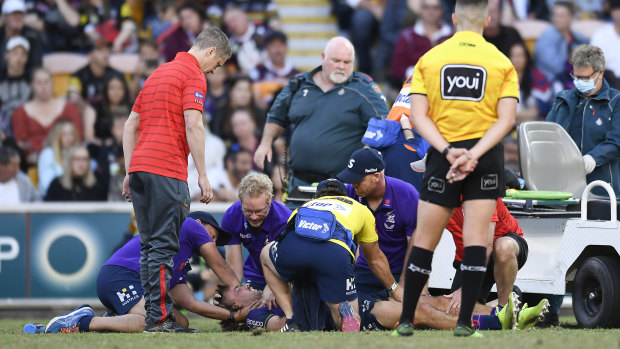 Ryan Papenhuyzen receives medical attention after Tyrell Fuimaono’s hit.