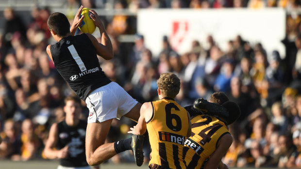 High flier: Carlton's Jack Silvagni gets up over the pack to take a mark.