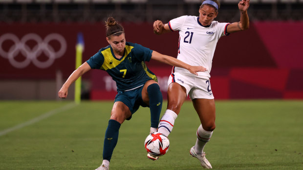 Steph Catley battles for possession.