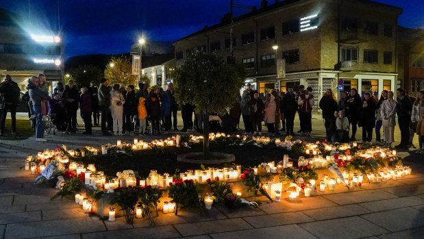Flowers and candles are placed at the scene of an attack on the Stortorvet in Kongsberg, Norway.