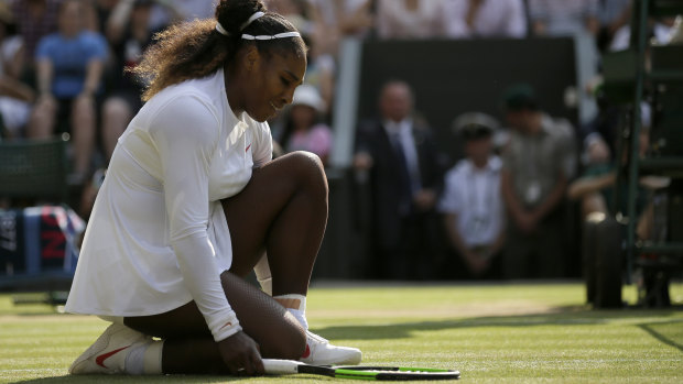 So close: Serena Williams kneels at the net during the Wimbledon final.