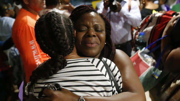 Jasmine Farrinton hugs Roshane Eyma after she was rescued and flown to Nassau after Dorian devastated the Abaco Island, Bahamas.