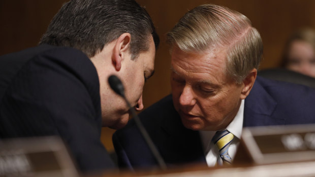 Senator Ted Cruz (left) and Senator Lindsey Graham (right) have a hushed conversation in dramatic scenes minutes before the scheduled vote.