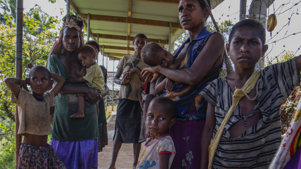Families wait at a health clinic in Papua New Guinea. Australia has increased its aid spending in Pacific region this financial year.