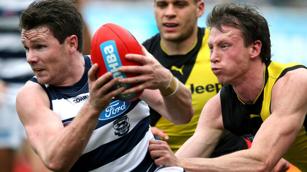 Patrick Dangerfield (left) is tackled by Dylan Grimes.