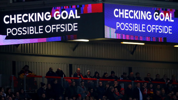 A VAR check takes place during a Premier League game.