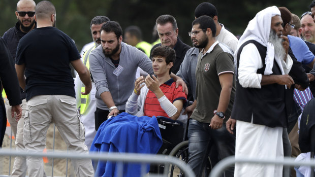 "I don't want to be here alone": Zahid Mustafa, centre, the brother of Hamza and son of Khaled Mustafa, who were killed in the shooting. 