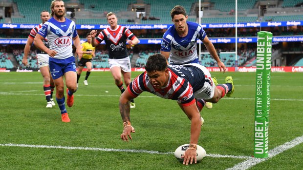 Latrell Mitchell dives over for one of his two tries on Sunday before being overlooked for Origin II.