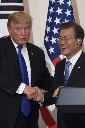 Trump and Moon shake hands during a joint press conference at the presidential Blue House in 2017.