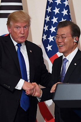 Trump and Moon shake hands during a joint press conference at the presidential Blue House in 2017.