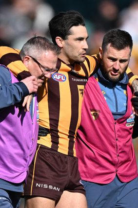 Chad Wingard is helped from the field.