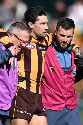 Chad Wingard is helped from the field in Launceston.