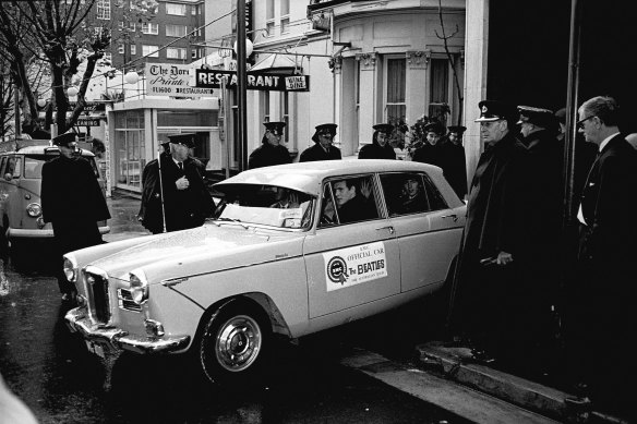 George Harrison peers out at rainy Sydney as the Beatles' car leaves the Sheraton Hotel. 