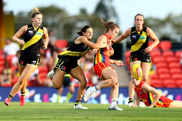 Jamie Stanton, centre, is tackled. 