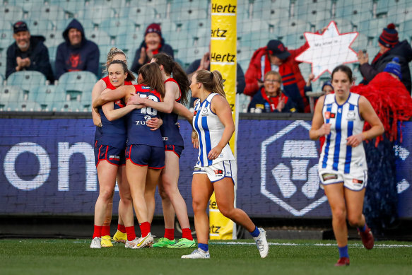 Daisy Pearce celebrates a goal with Demons teammates.