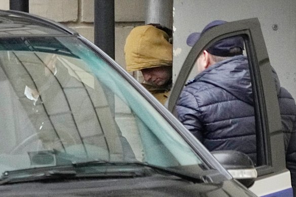 Wall Street Journal reporter Evan Gershkovich is escorted by officers from the Lefortovsky court to a bus in Moscow.