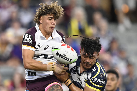 Reece Walsh contests the ball with the Cowboys’ Jeremiah Nanai, despite nursing a fractured hand.