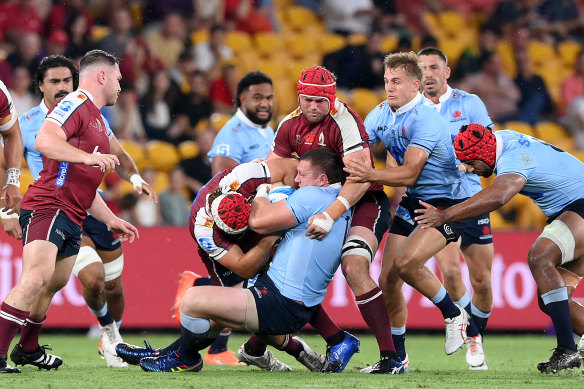 Angus Bell is tackled in Brisbane