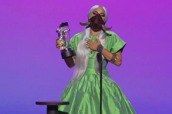For the Song of the Year award, Lady Gaga wore a gigantic iridescent emerald green shirtdress ballgown from Christopher John Rogers and a matching bejeweled and tusked Lance V. Moore mask.