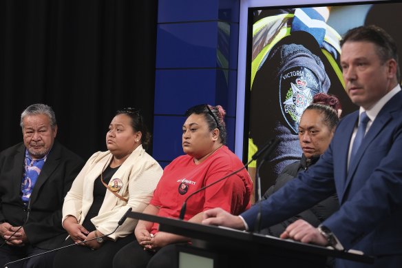 Detective Inspector Tim Day (right) addresses the media with Mr Tuivasa’s relatives.