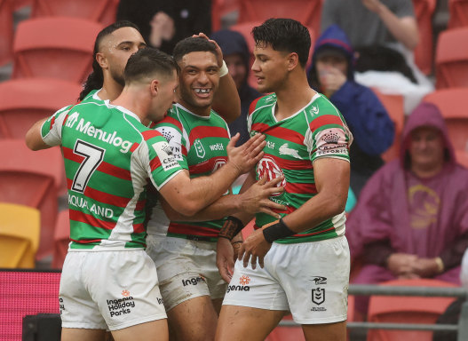 South Sydney celebrate a try by Taane Milne (centre).