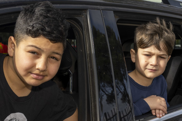 Al-Taqwa College students Khaled and Mohammed Jawad queue outside the school for a COVID-19 test.