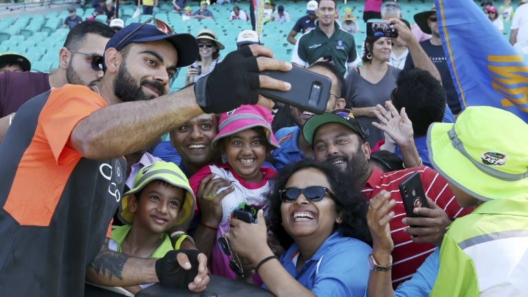 Virat Kohli, dismissed on day one, meets adoring fans before play on day two. 