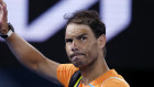 Rafael Nadal waves as he leaves Rod Laver Arena following his straight sets second round loss to 27-year-old American Mackenzie McDonald.