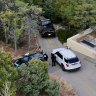 Law enforcement officials talk outside the home of actor Gene Hackman and his wife Betsy Arakawa.