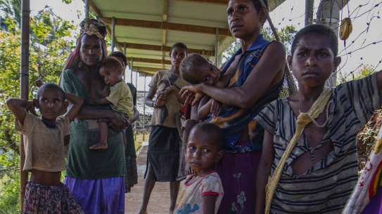 Poor families wait at a health clinic in Papua New Guinea. Australia has increased its aid spending in the region this financial year