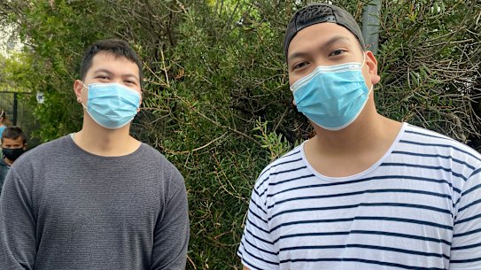 Justin Salvador, right, and his brother John in line for a COVID test in Caringbah on Thursday.