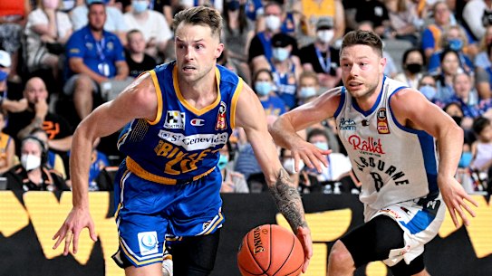 Matthew Dellavedova (right) battles Brisbane’s Nathan Sobey.