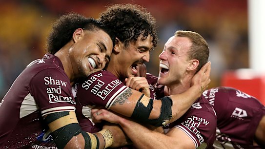 The Sea Eagles celebrate a try against the Tigers at Suncorp Stadium after the NRL’s relocation to Queensland.