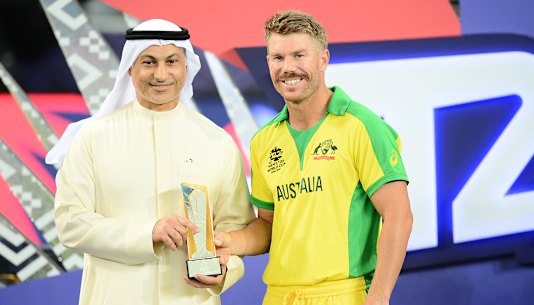David Warner receives his Player Of The Tournament award the 2021 ICC T20 World Cup final.