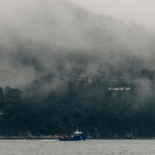 A Huon Aquaculture boat travels up the D’Entrecasteaux Channel, which locals say is polluted by effluent from fish farms.