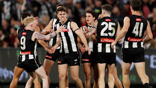 Josh Carmichael is congratulated by Magpies teammates after a goal.