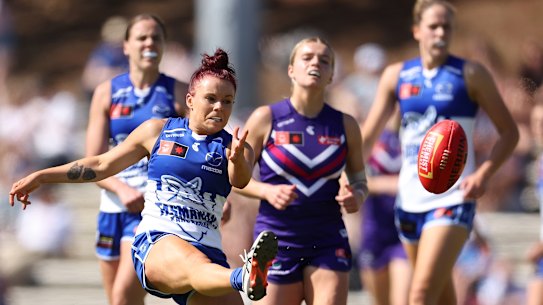 Jenna Bruton drives the ball forward for the Kangaroos.