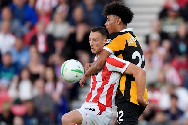 Hull City’s Lucas Herrington challenges Stoke’s Robert Bozenik in their Carabao Cup tie.